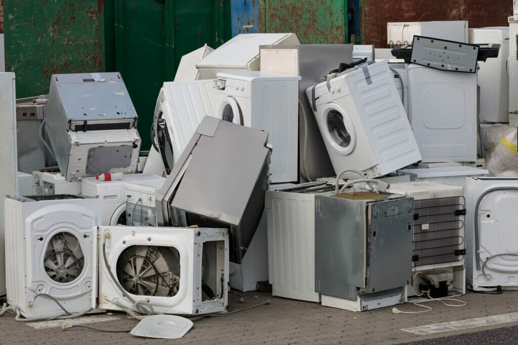 Old electrical appliances in container of recycling center.
